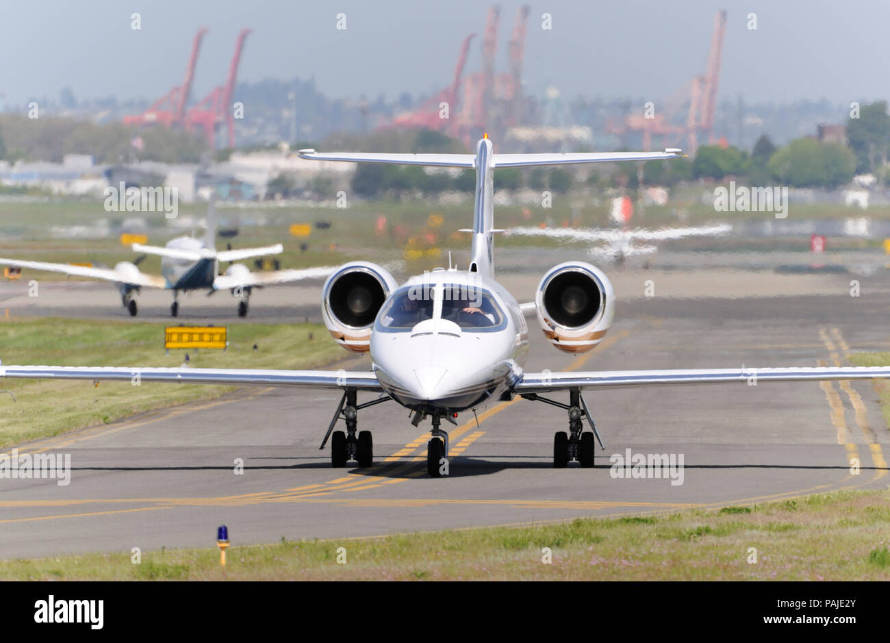 Bombardier Learjet 35A taxiing with Cessna 172 Skyhawk and FAA Beech King Air C90GT waiting in a queue Stock Photo