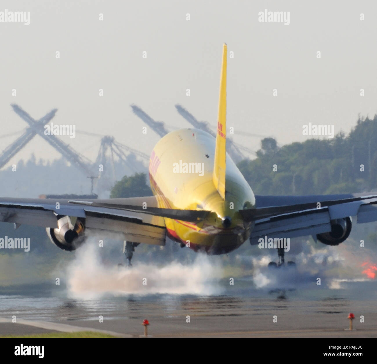 DHL Airways Boeing 767-200 freighter landing with tyre-smoke Stock Photo