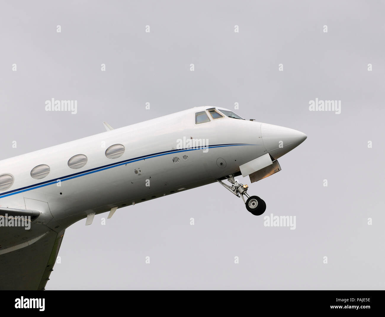 nose of Grumman G-1159 Gulfstream 2 / II climbing out after take-off with undercarriage retracting Stock Photo