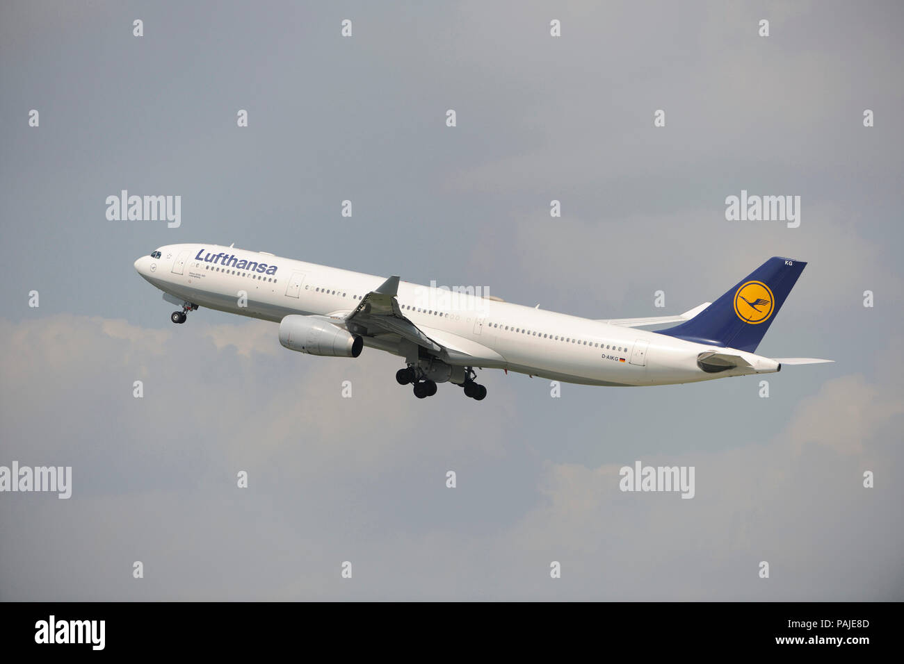 Lufthansa Airbus A330-300 climbing out after take-off with undercarriage retracting Stock Photo