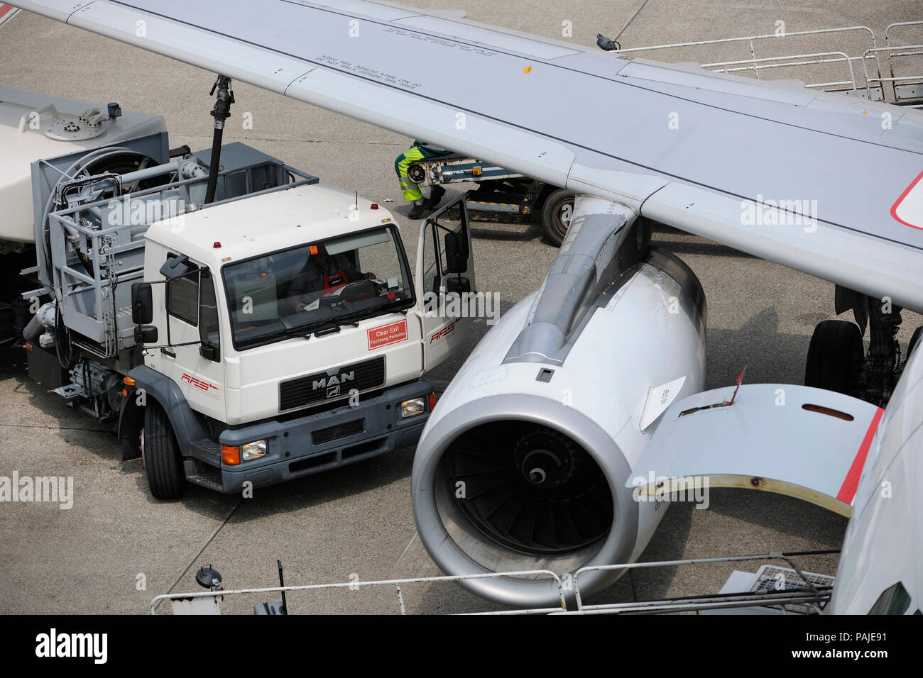 refuelling bowser with hose attached under the wing of an Air Berlin Airbus A319 parked Stock Photo