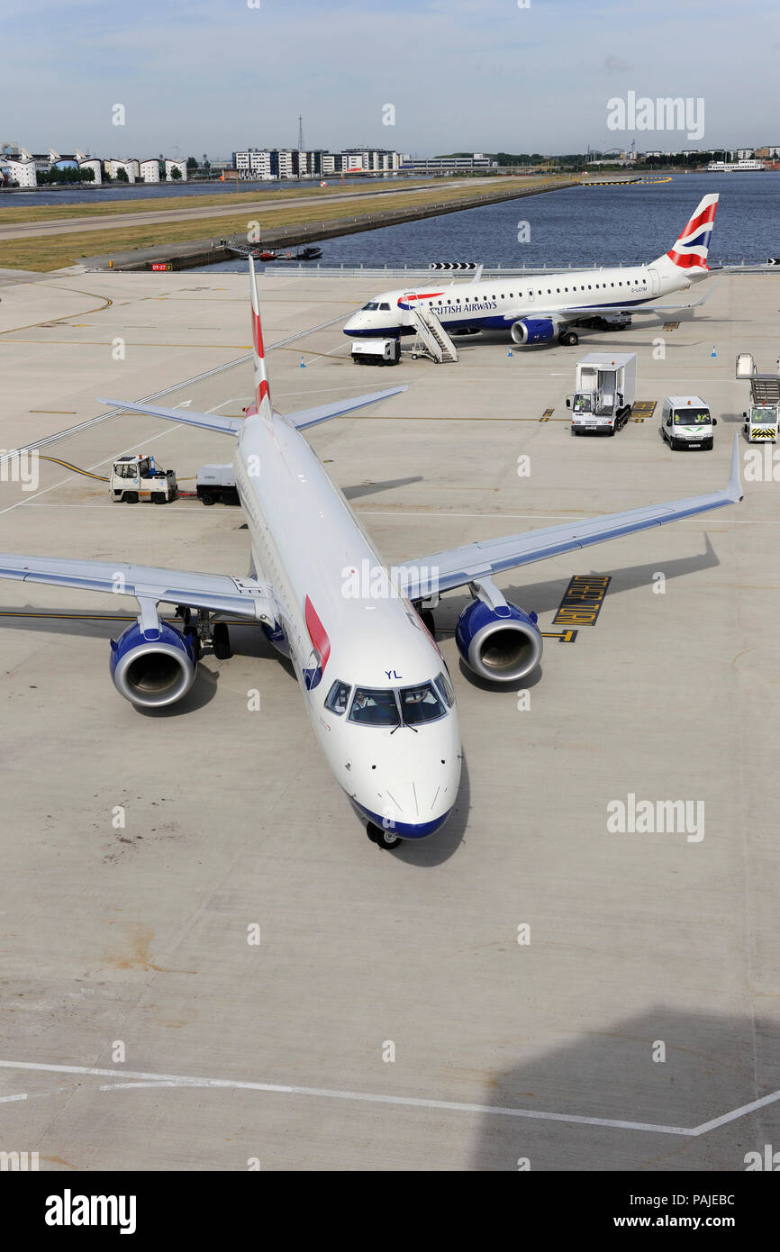 British Airways BA CityFlyer Embraer 190LR taxiing with Embraer 190 parked behind at London City Stock Photo