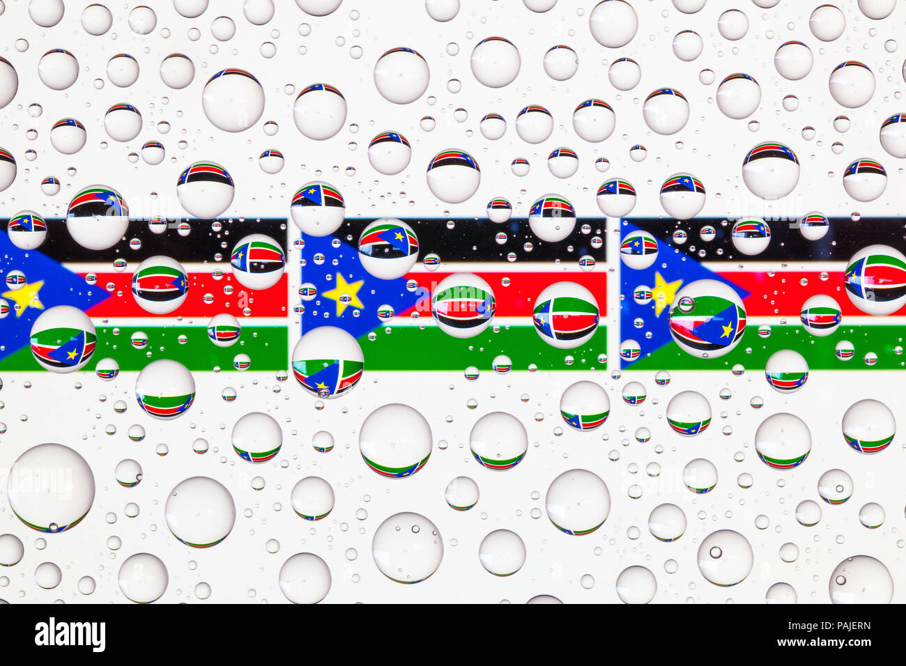 Flags of South Sudan behind a glass covered with raindrops Stock ...