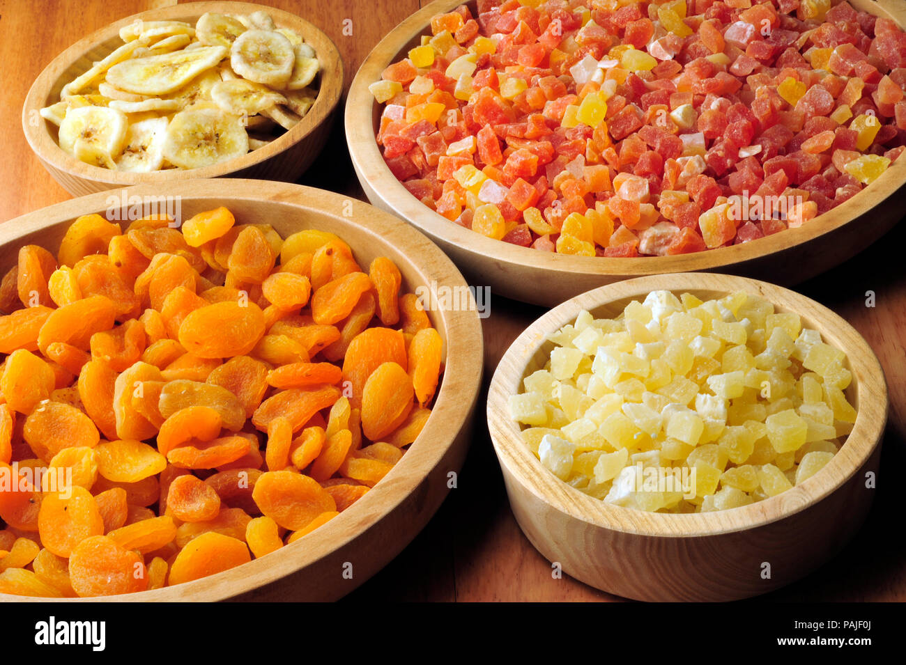 Dried and candied fruits in wooden bowls Stock Photo Alamy