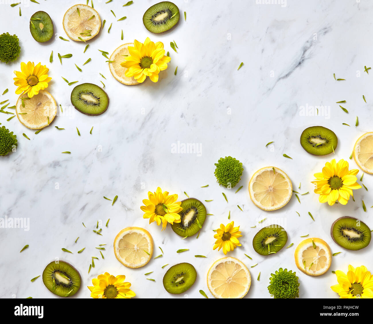Flowers pattern from natural yellow green flowers, slices fruits, green flower petals. Space for