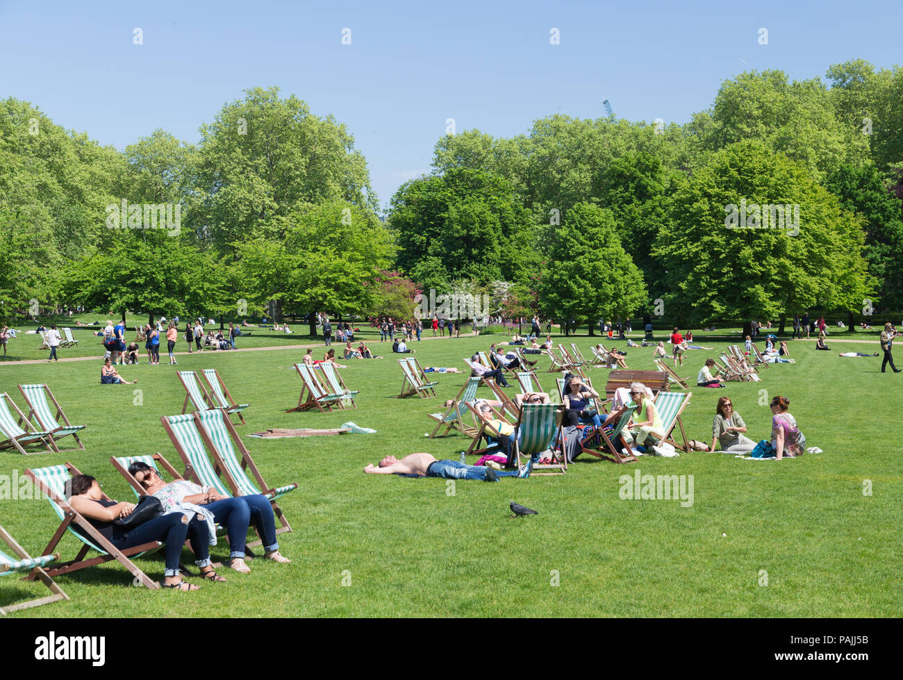 Office workers relax in St James's Park at lunchtime on a sunny spring day in London, UK Stock Photo
