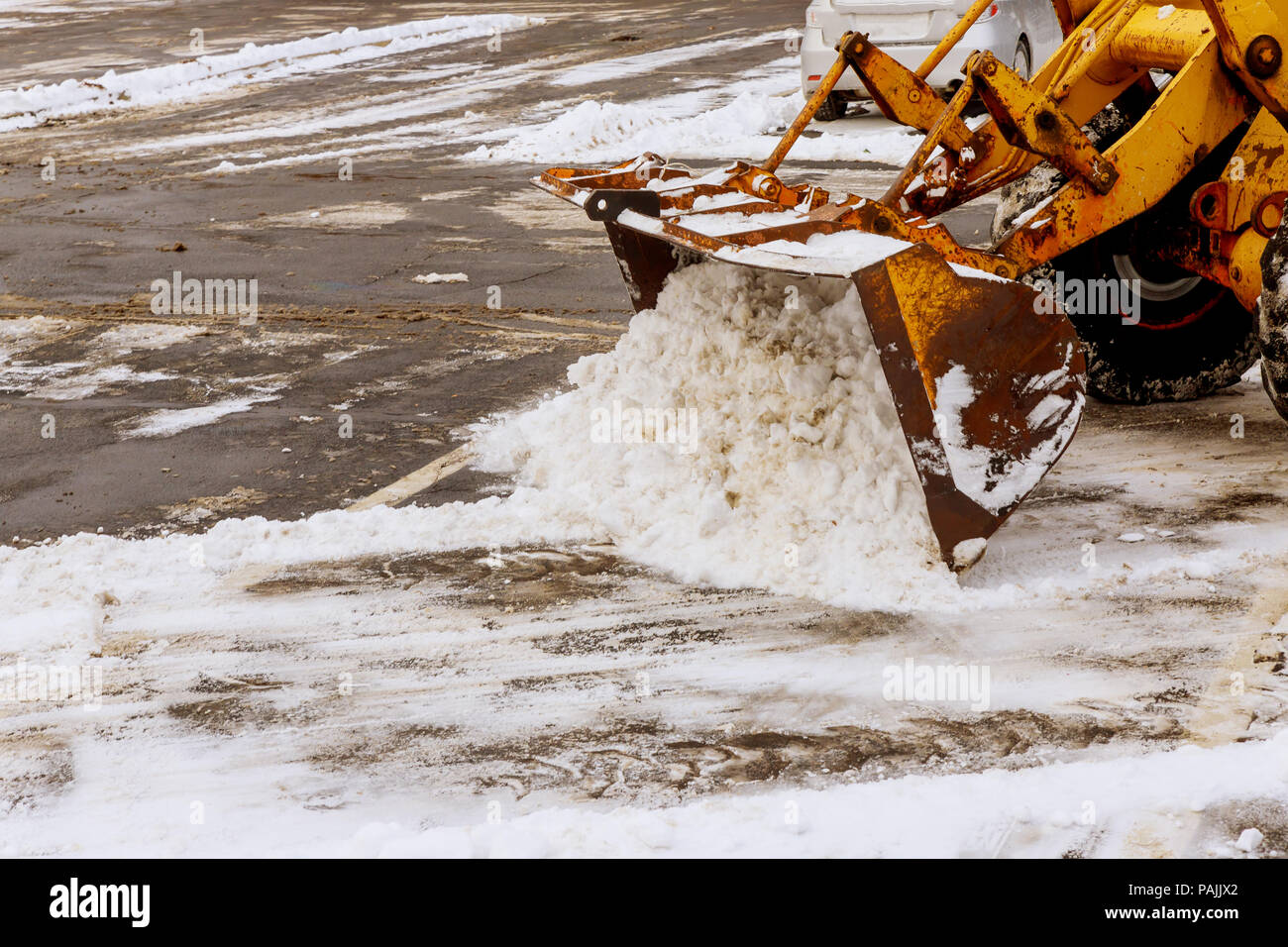 Remove Snow Machine Snow removal by a tractor in a parking lot after snowfall, Snow removal ...