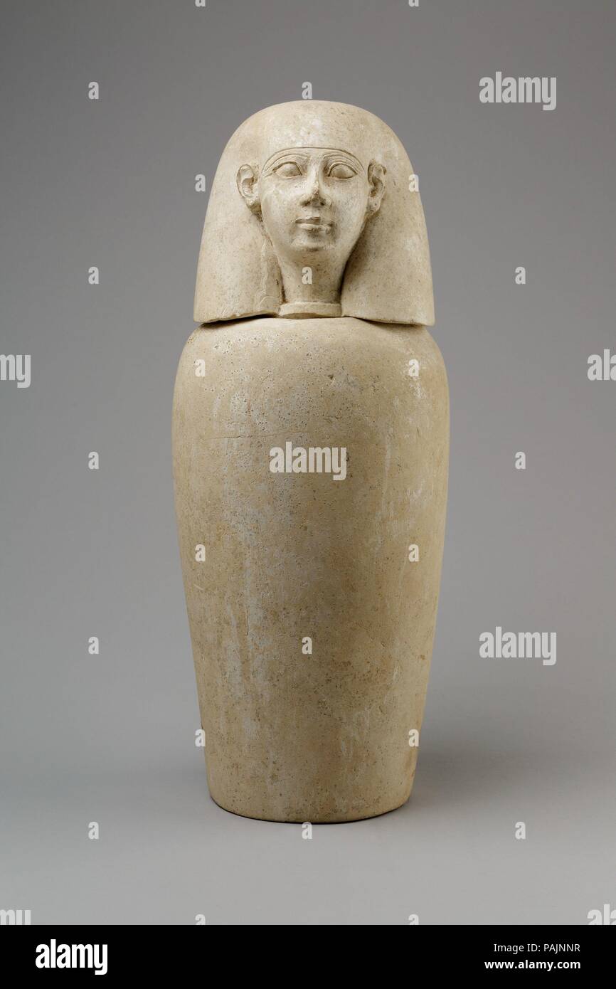 Canopic jar with human head (Imsety). Dimensions: Jar: H. 25.4 cm (10 in.); d. 15.3 cm (6 in.); diam. of base 10.5 cm (4 1/8 in.); diam. of mouth 8 cm (3 1/8 in.); circ. 45.2 cm (17 3/16 in.); Lid: 13 cm (5 1/8 in.); w. 12.5 cm (4 15/16 in.); d. 12.2 cm (4 13/16 in.); diam. of foot 6.5 cm (2 9/16 in.); Jar with Lid: H. 36.3 cm (14 5/16 in.); diam. 14.6 cm (5 3/4 in.). Date: ca. 800-650 BC.  This canopic is part of a set (13.180.1--.4) found in a Ptolemaic cemetery at Thebes. Use of canopics had gone out of fashion at that period, however, so these are certainly reused. Their style suggests the Stock Photo