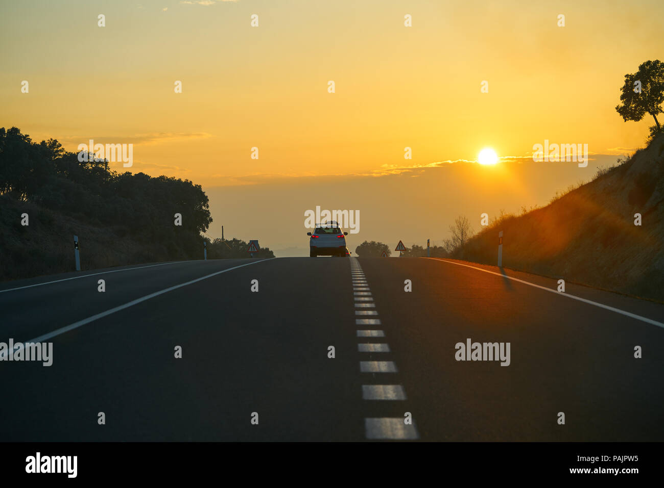 Sunset on the road with golden sky in Spain Stock Photo