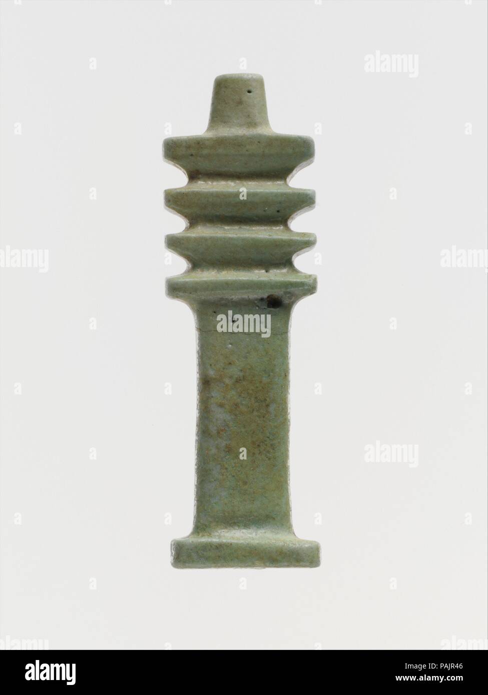 Faience djed-pillar amulet. Culture: Egyptian. Dimensions: H.: 1 3/4 in. (4.5 cm). Date: 664-30 B.C..  Symbolic objects used for amulets include a menat-pendant, the djed-sign, and a papyrus capital, all common in Egyptian architecture.  A pectoral used on mummies, a bunch of grapes or other clusters of fruit, and an inscribed bead are also represented. Museum: Metropolitan Museum of Art, New York, USA. Stock Photo
