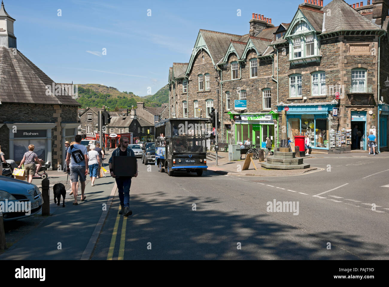 People tourists visitors in the town centre in summer Ambleside Cumbria England UK United Kingdom GB Great Britain Stock Photo