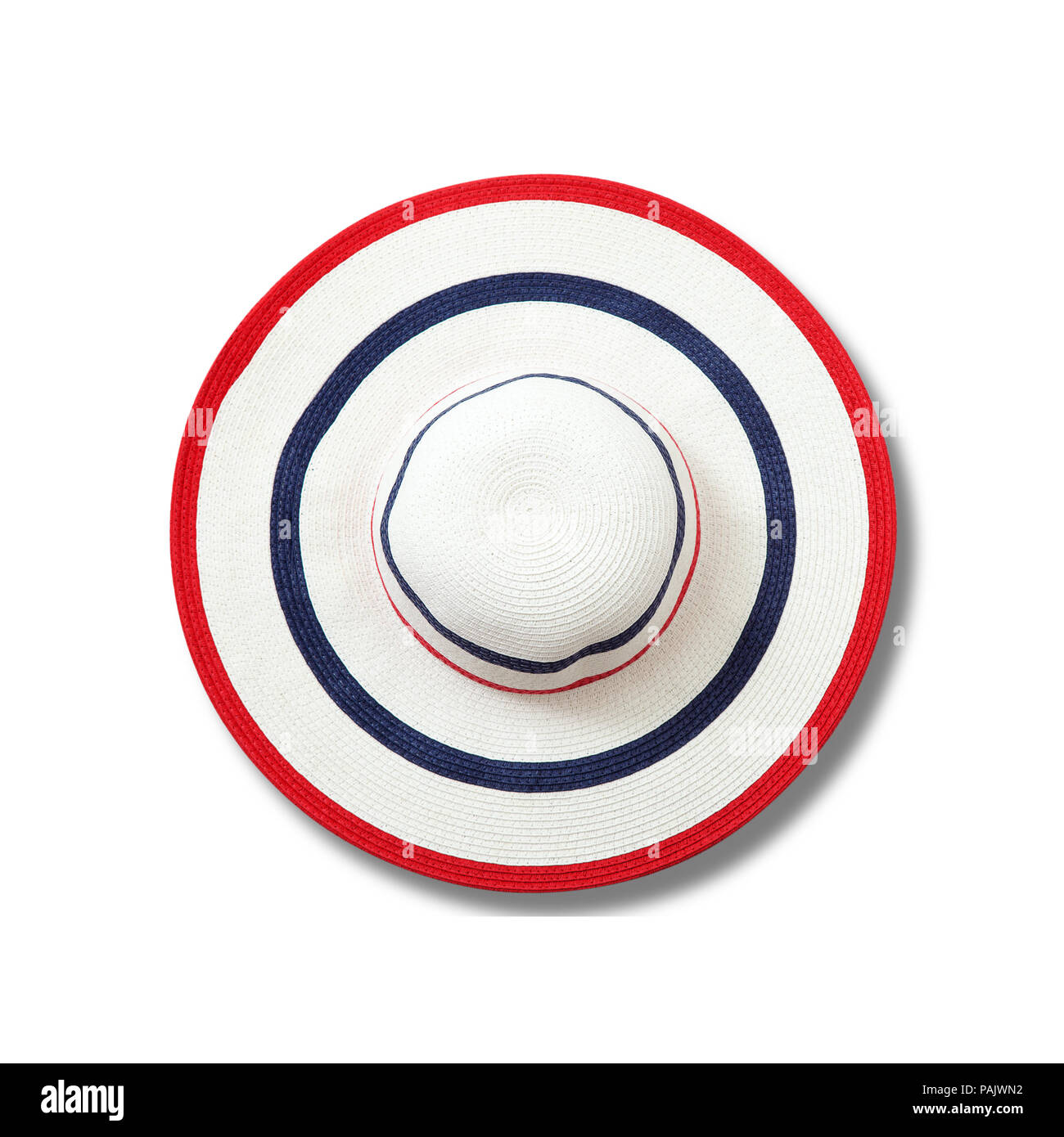 Pretty straw hat with shadow on white background. Beach hat top view