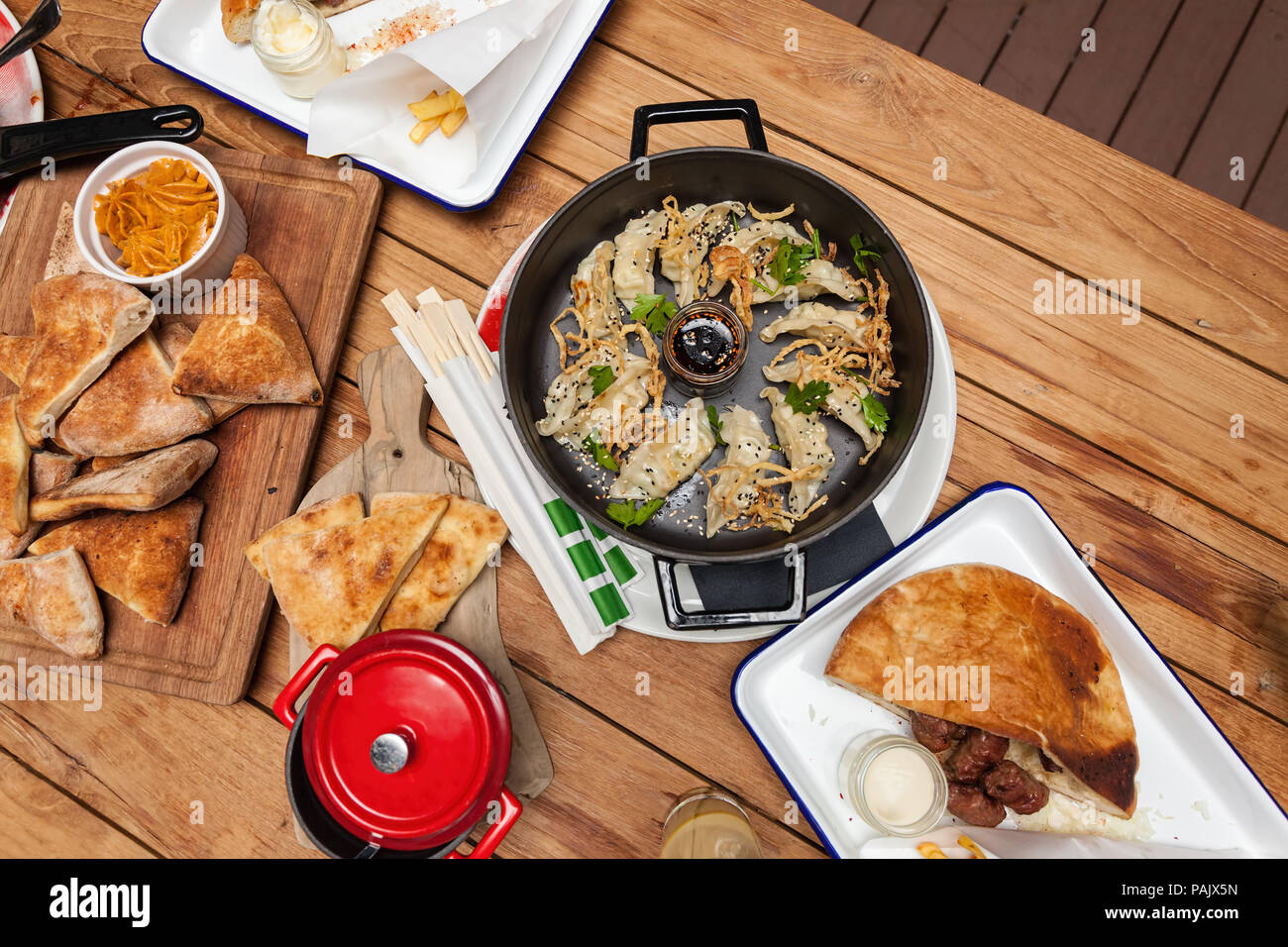 Rice paper dumplings served in iron pot on wooden background. Top view. Ready to eat. Stock Photo
