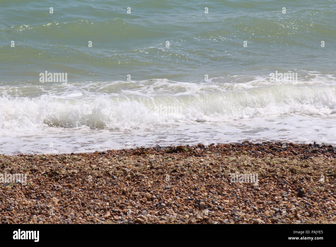 Tide Coming In Tide coming in on pebble beach Stock Photo - Alamy