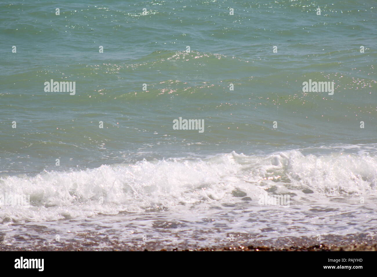 Tide Coming In Tide coming in on pebble beach Stock Photo - Alamy