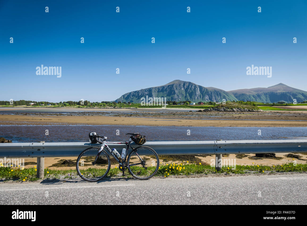 cycle parked against some arnco with mountain backdrop, Norway Stock Photo