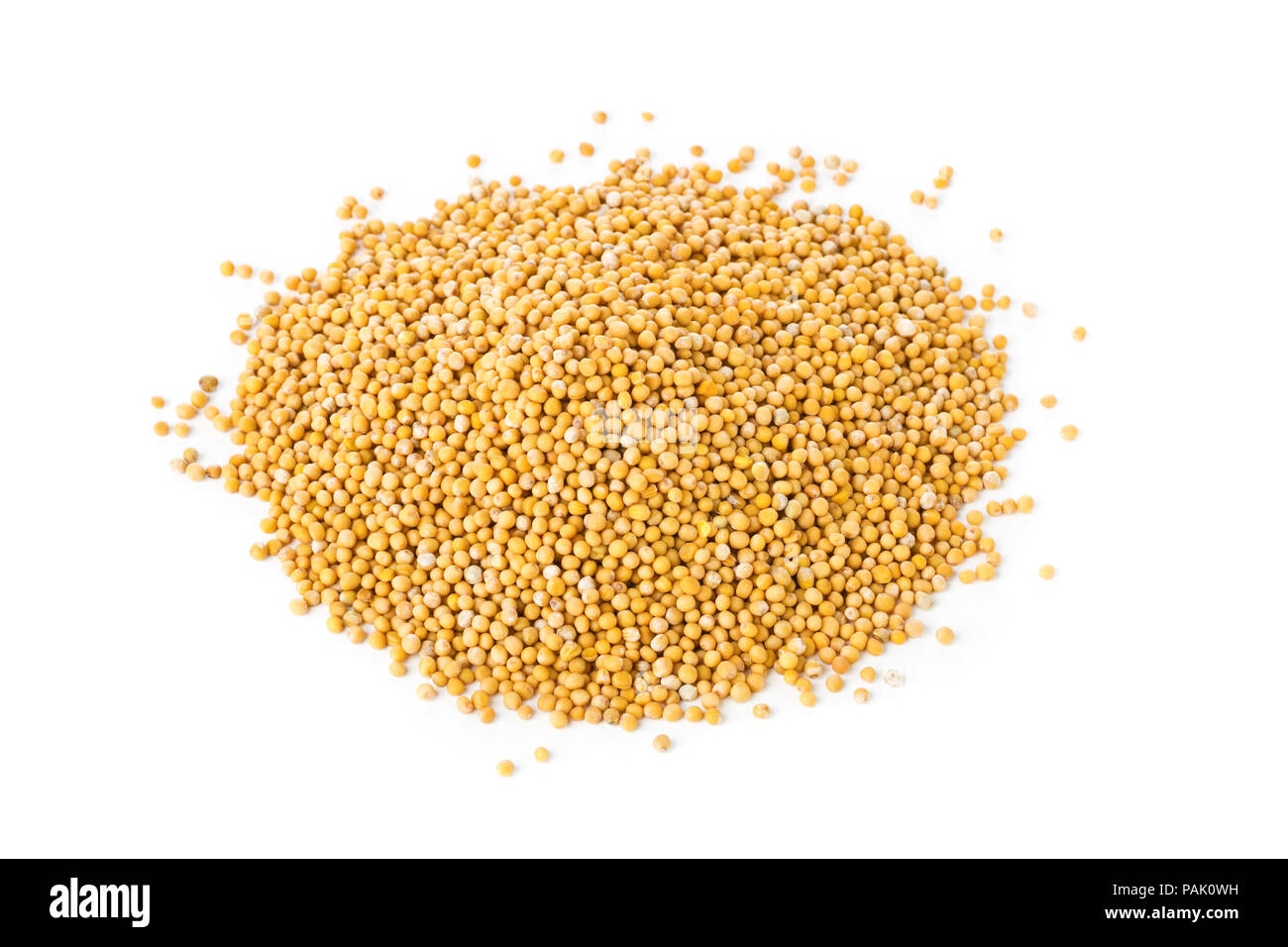 Heap of raw, unprocessed mustard seed kernels on white background Stock Photo