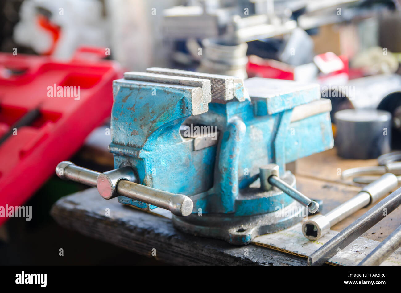 Rotating Blue Vice On A Wood Workbench In A Workshop With A