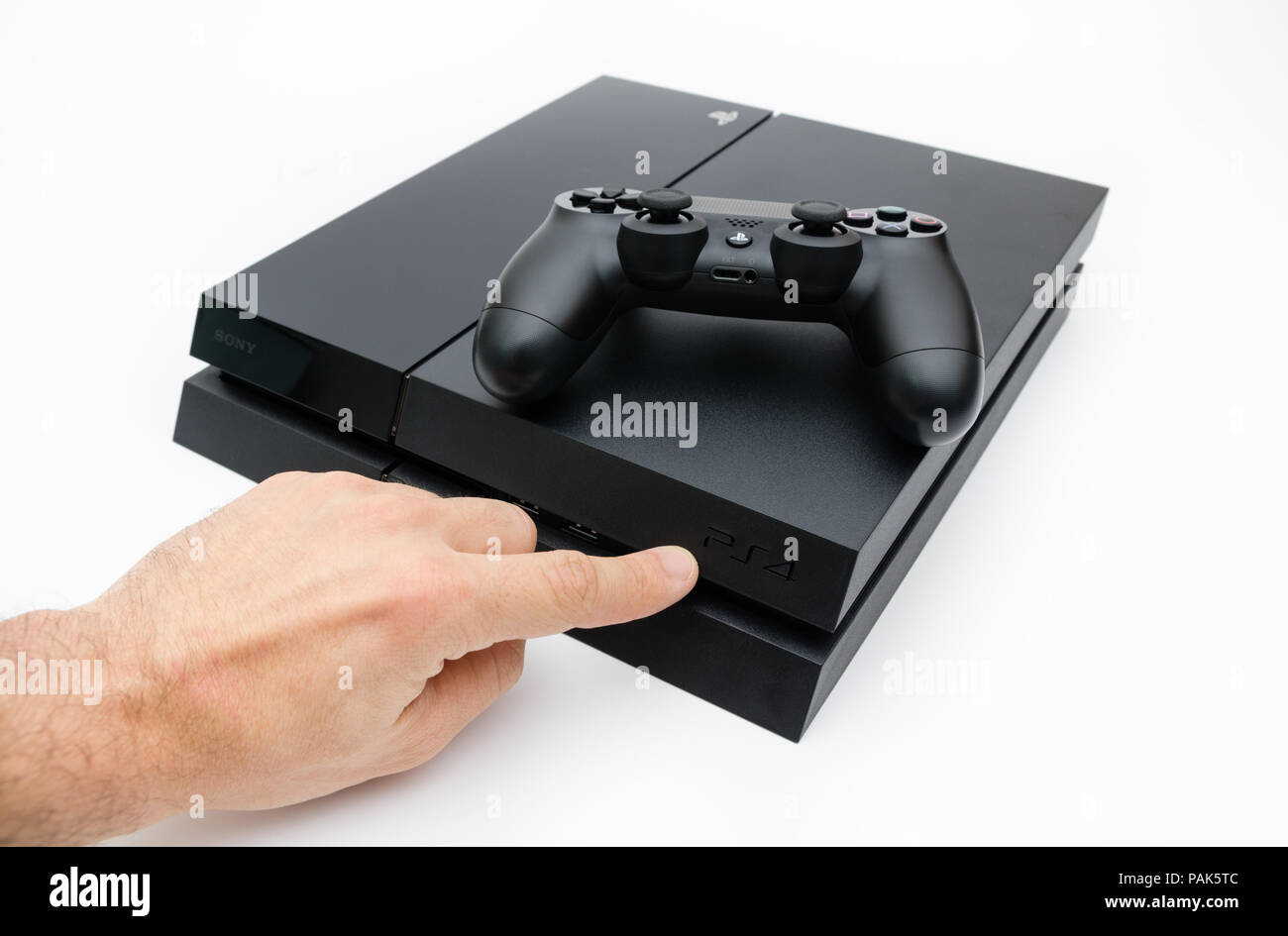 CLUJ-NAPOCA, ROMANIA - 25 FEBRUARY: Illustrative editorial image of Sony  Playstation 4 console with Dualshock 4 controller and a hand showing the  PS$ Stock Photo - Alamy