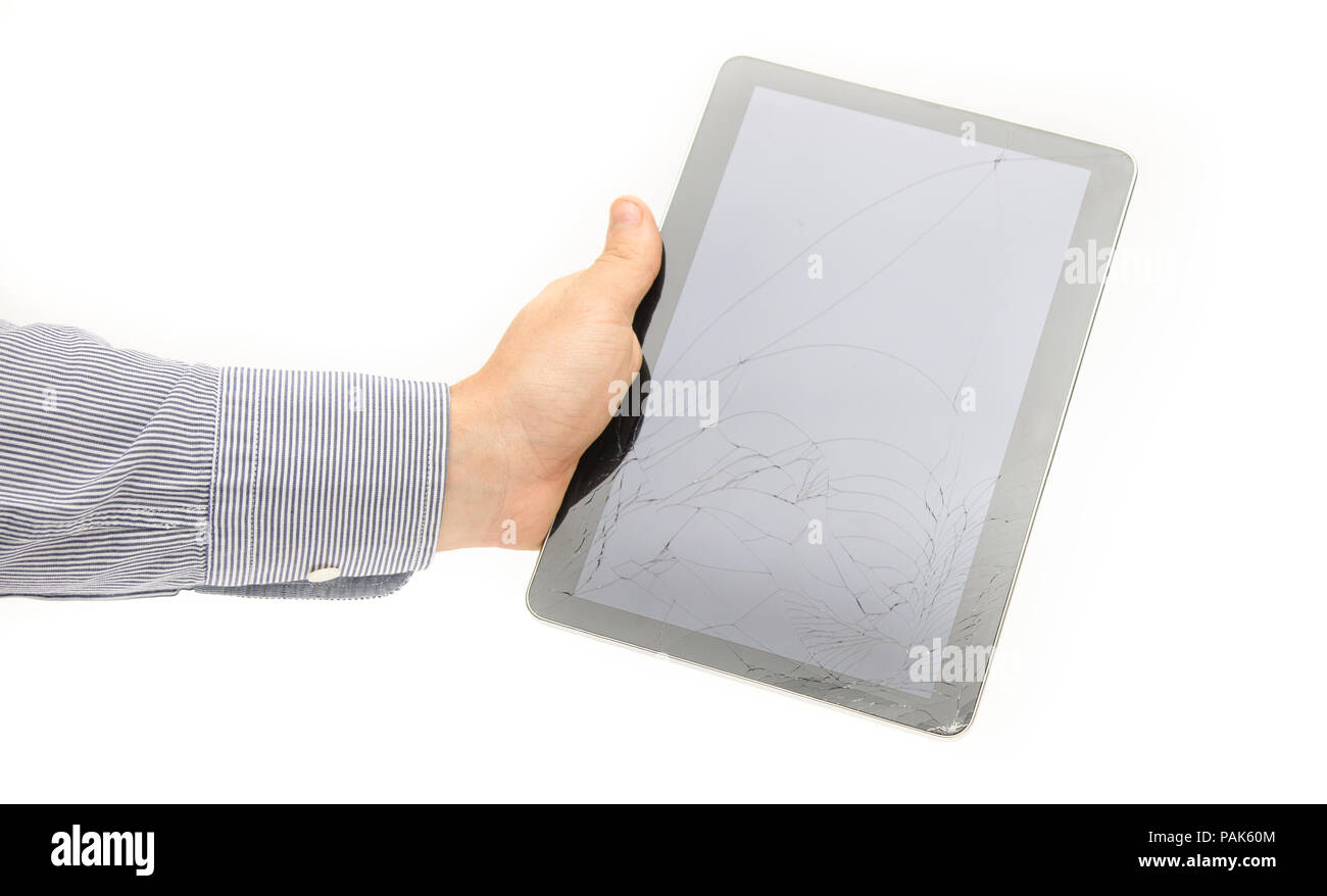 Broken cracked tablet touch screen glass display in a business man hand on a white background suggesting fix and repair services under warranty and th Stock Photo