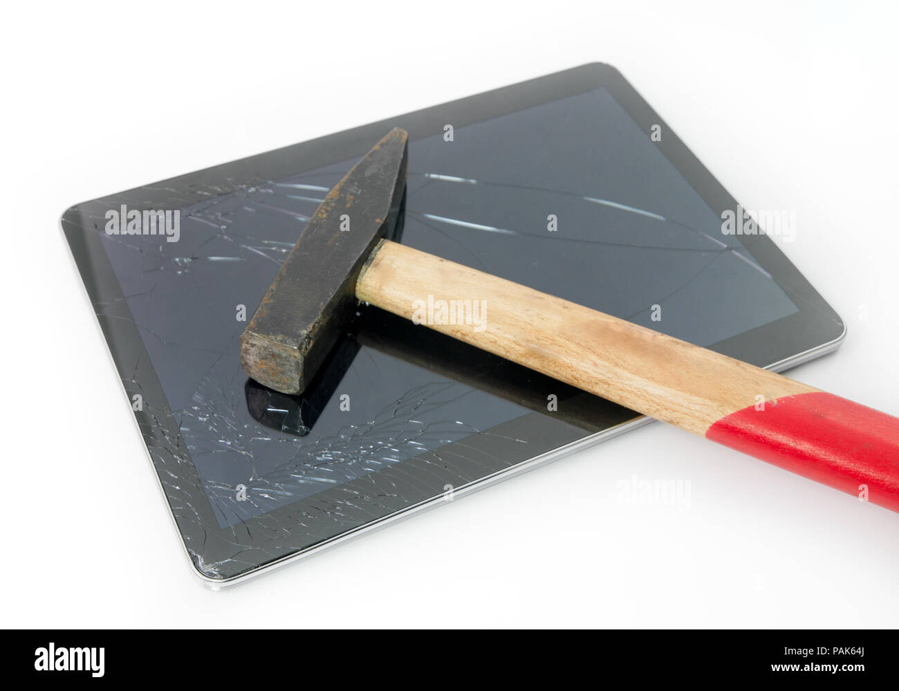 Hammer on a tablet with a cracked broken touchscreen glass suggesting the  need for repair and service under warranty Stock Photo - Alamy