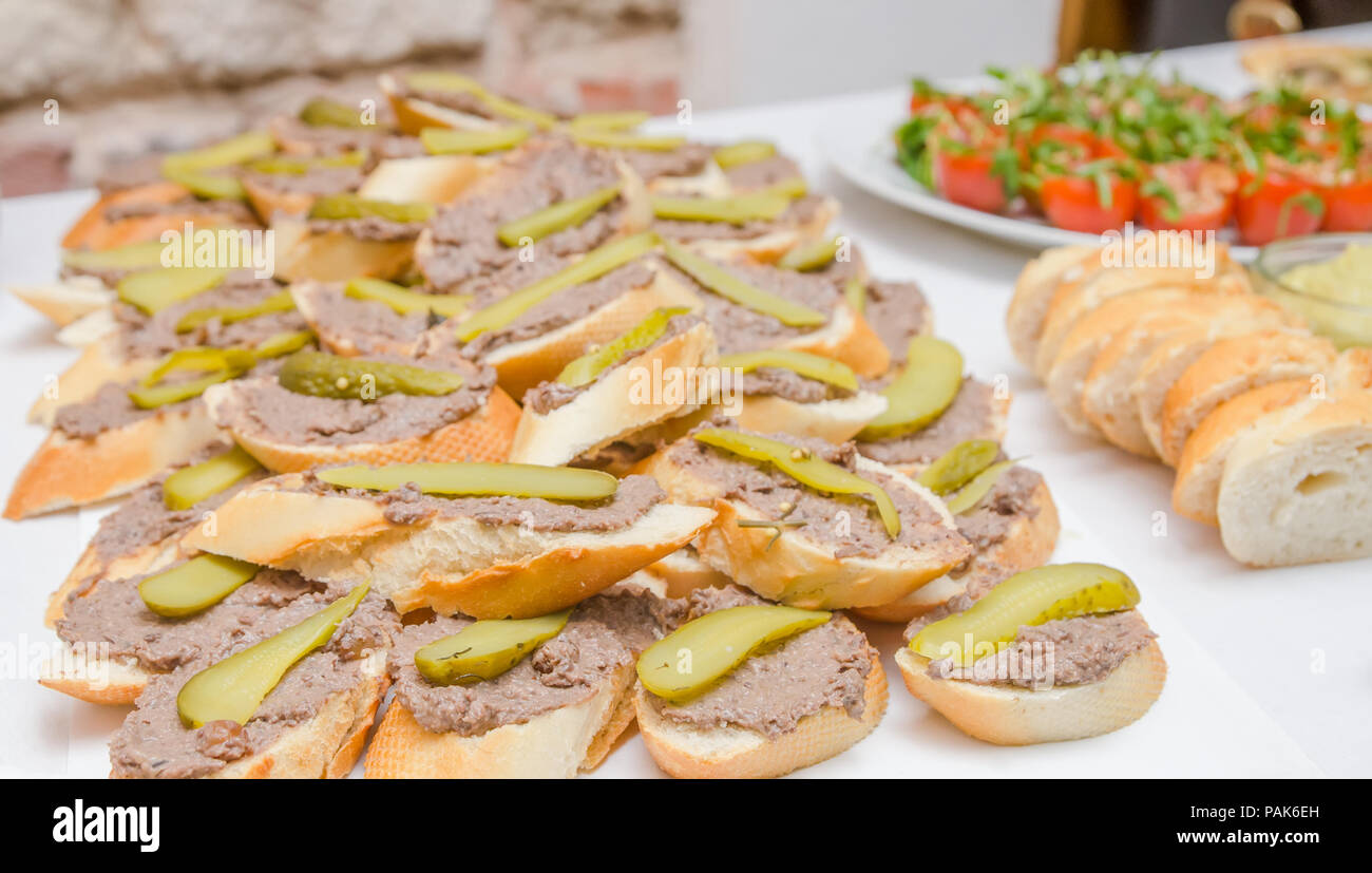 A pile of pate appetizers on small slices of bread at a restaurant
