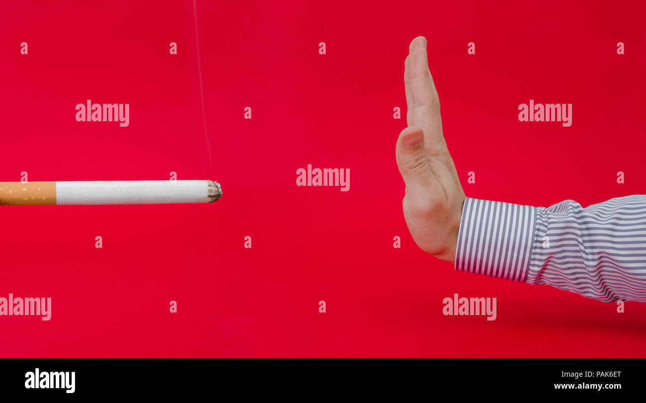 Say no to smoking suggested by a business man refusing a giant lit ...