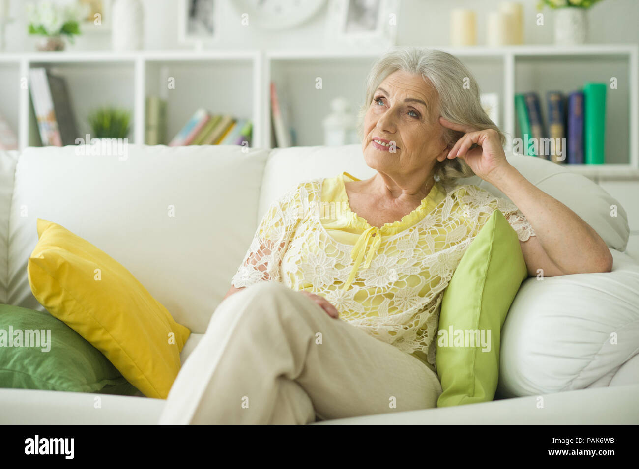 Beautiful mature woman on sofa hi-res stock photography and images - Alamy