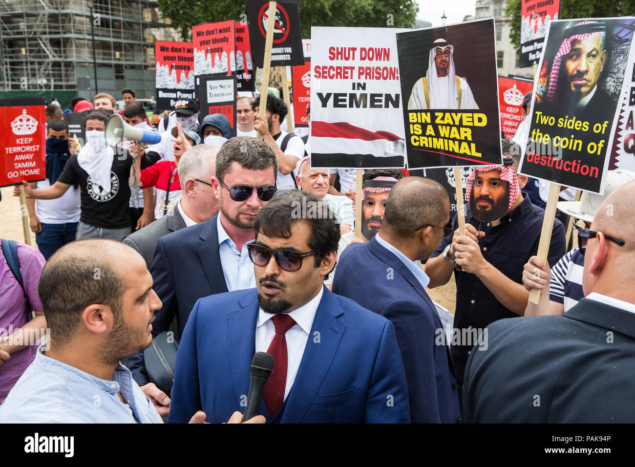 London, UK. 23rd July, 2018. Khalid Al-Hail, founder and president of the Qatar National Democratic Party (QNDP), speaks to the media in front of a protest by opponents of a visit to the UK by Qatar’s Emir Tamim Bin Hamad Al Thani in Parliament Square against Qatari support for extremist and terrorist groups. There was also a smaller counter-protest. Emir Tamim is expected to meet Prime Minister Theresa May during his visit. Credit: Mark Kerrison/Alamy Live News Stock Photo