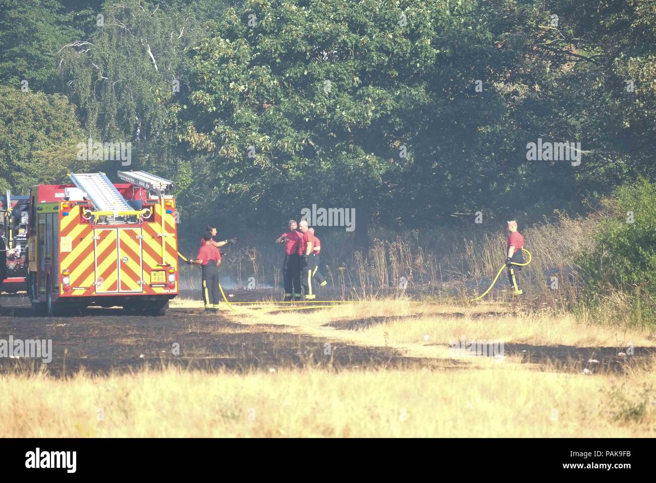 London, UK. 23rd July 2018. . Twenty fire engines and around 125 firefighters tackle a  grass fire on Woolwich Common off Ha Ha Road. Credit : Claire Doherty/Alamy Live News Stock Photo