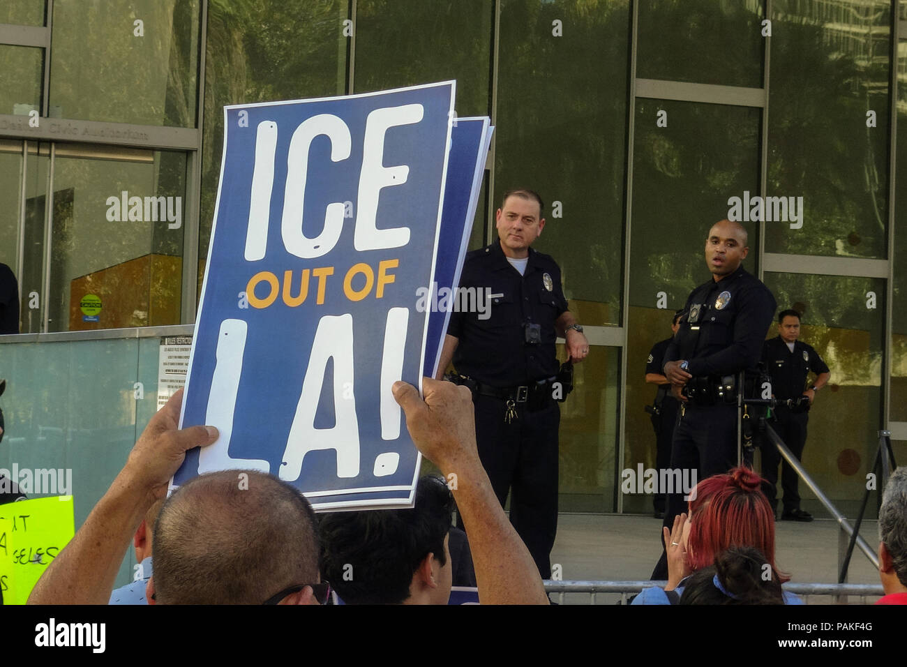 Los Angeles, USA - July 23 2018: A protestor holding ' ICE out of LA' sign during the rally outside LAPD headquarters while Incumbent L.A. County Sheriff Jim McDonnell and retired Lt. Alex Villanueva engaged in a contentious debate Monday in downtown Los Angeles on July 23rd, 2018 (Credit: Aydin Palabiyikoglu/Alamy Live News Stock Photo