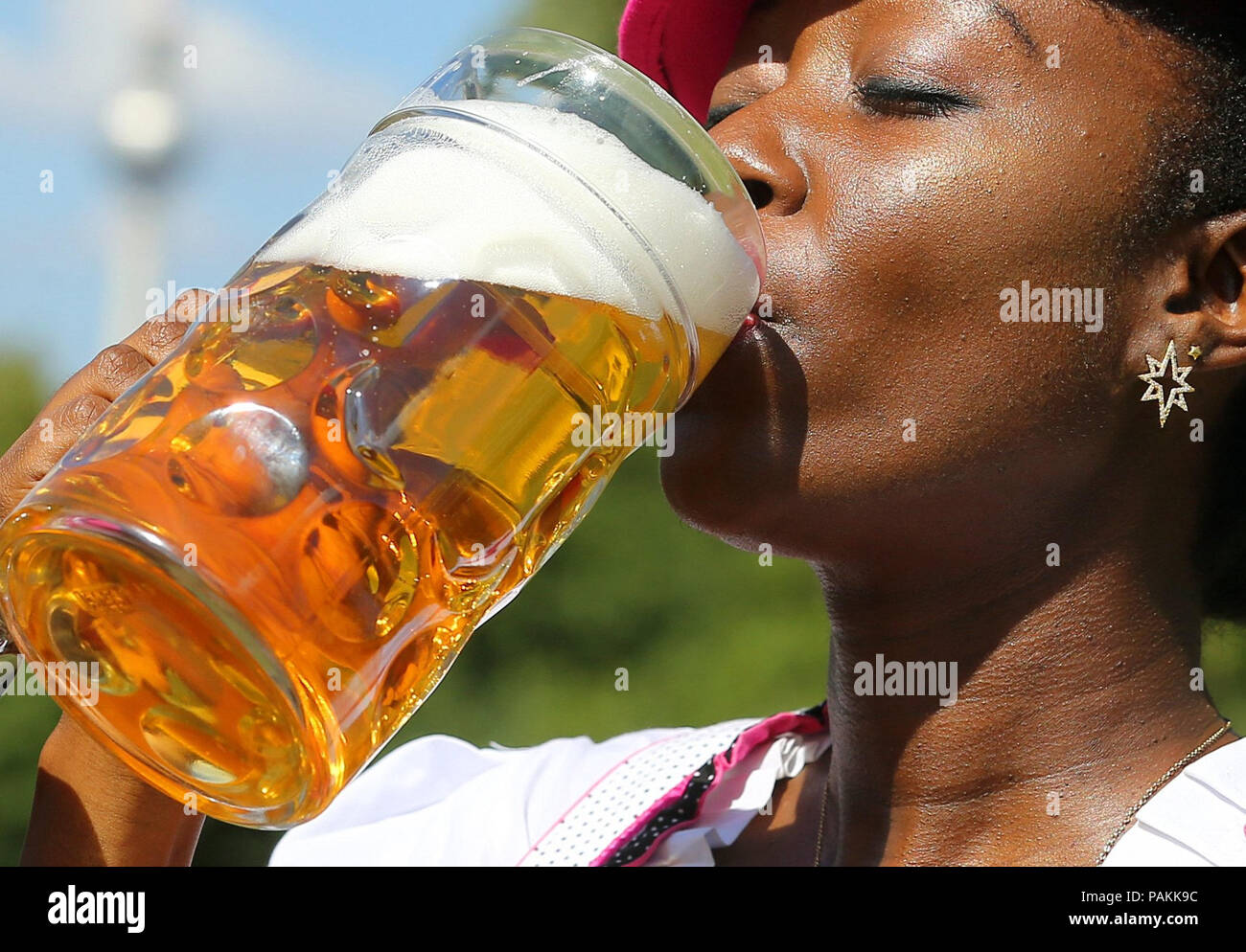 24 July 2018, Germany, Berlin: During a press event for the 22nd International Berlin Beer Festival on Karl-Marx-Allee in the Friedrichshain-Kreuzberg district, the model Ayanna tries a glass of beer. The beer festival will take place from 3 to 5 August 2018 between Frankfurter Tor and Strausberger Platz. Photo: Wolfgang Kumm/dpa Stock Photo