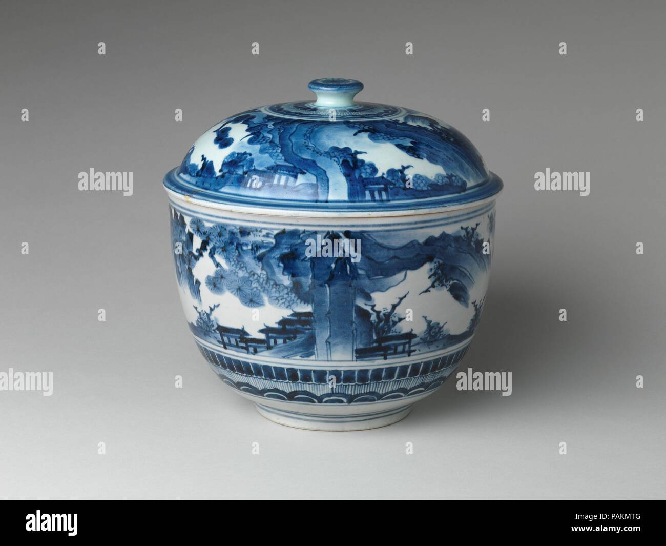 Tureen with Landscape. Culture: Japan. Dimensions: Diam. 10 in. (25.4 cm). Date: late 17th century.  This large tureen is a piece of export porcelain made for the European trade that was conducted by the Dutch during the Edo period (1615-1868). It is decorated in the Transitional style, in which a stylized landscape scene is executed in underglaze blue on a white surface. This style originated in Chinese export porcelain and was popular in Europe in the first half of the seventeenth century. When, toward the middle of that century, the Dutch porcelain trade was carried out primarily with Japan Stock Photo