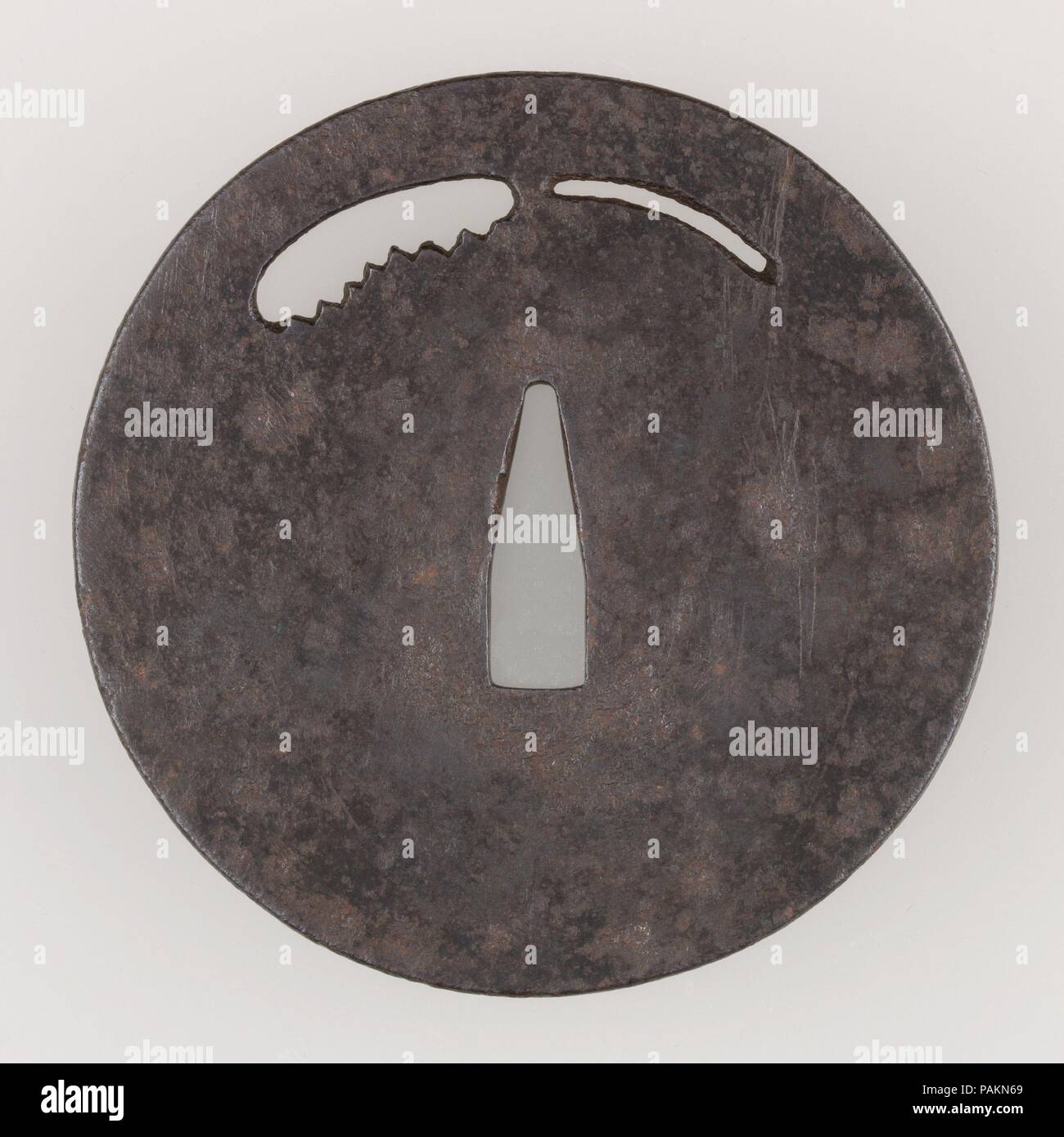 Sword Guard (Tsuba). Culture: Japanese. Dimensions: Diam. 3 3/4 in. (9.5 cm); thickness 1/8 in. (0.3 cm); Wt. 5.5 oz. (155.9 g). Date: late 14th century.  This tsuba features an openwork design of a saw. It is made in the so-called ko-tosho (swordsmith's) style. Museum: Metropolitan Museum of Art, New York, USA. Stock Photo