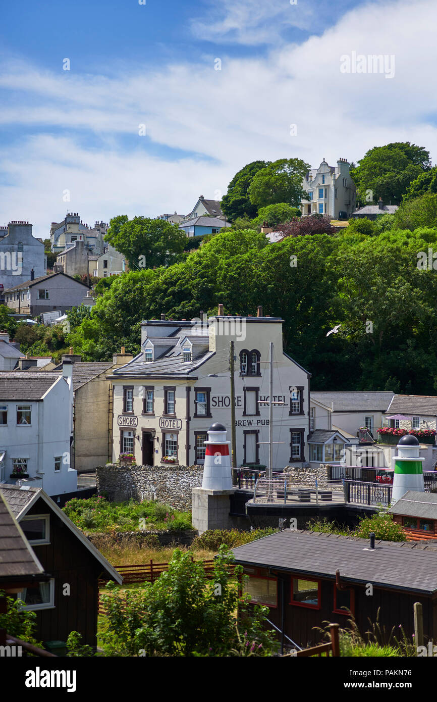 Attractive Laxey village is built on a steep hillside above the Shore public house and harbour Stock Photo