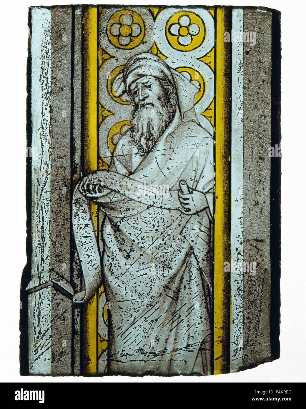 Prophet from a Throne of Solomon. Culture: French or South Netherlandish. Dimensions: Overall: 9 x 4 1/2 in. (22.9 x 11.4 cm). Date: ca. 1390-1410.  Uncommonly refined and gemlike in its painterly finesse, this stained-glass fragment with a prophet is related stylistically to the work of André Beauneveu (1335-1401/3), a gifted sculptor, painter, and illuminator from the South Lowlands, who was employed by King Charles V of France; Louis de Mâle, comte de Flandres; Philippe le Hardi, duc de Bourgogne; and Jean, duc de Berry, among others. A close parallel to the figure style--particularly to th Stock Photo