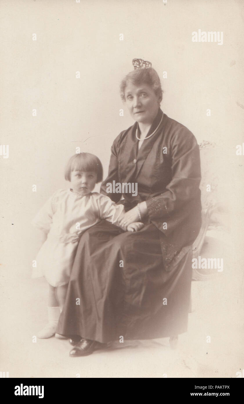 Vintage Studio Photograph of a Lady Holding a Child Stock Photo