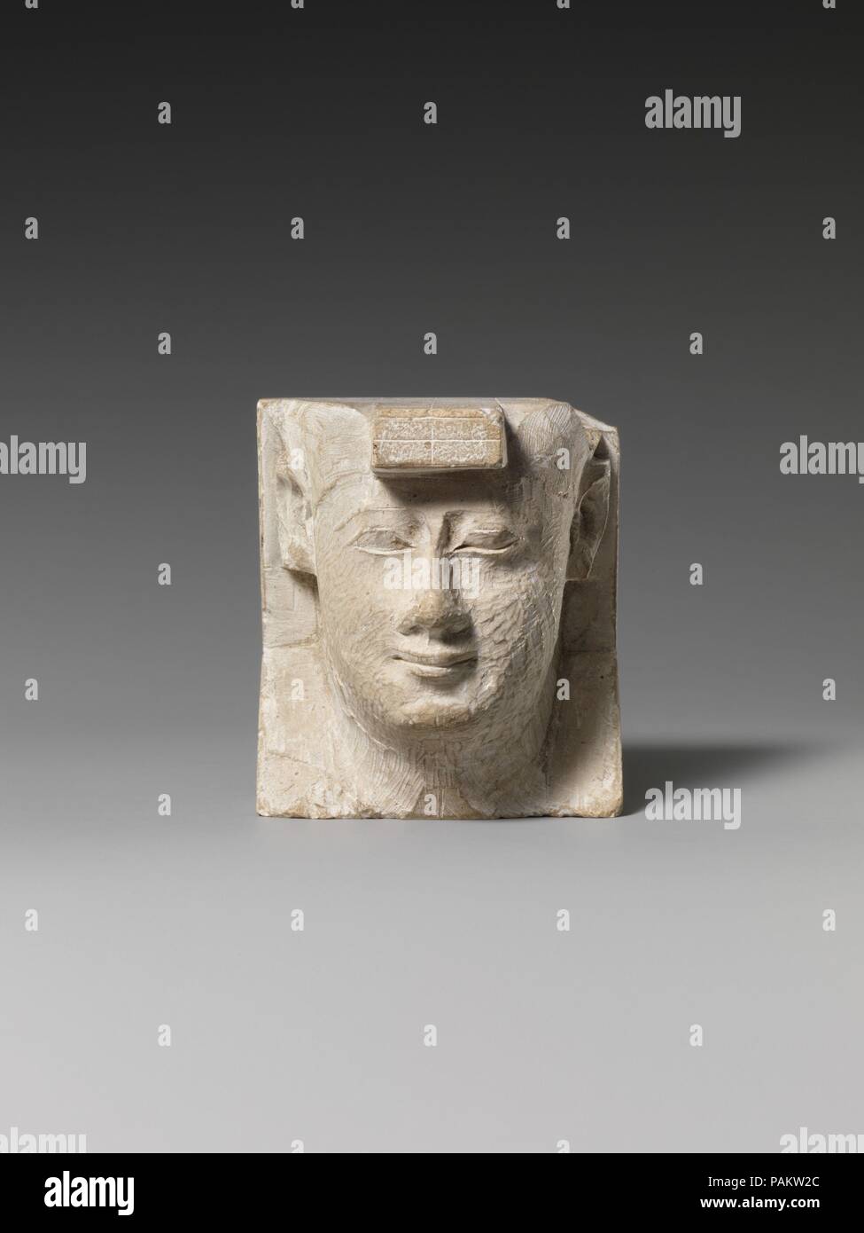 Royal bust. Dimensions: H. 6.5 cm (2 9/16 in.); W. 5.8 cm (2 5/16 in.); D. 4.8 cm (1 7/8 in.). Date: 400-200 B.C..  Small Late Period and Ptolemaic reliefs or sculptures that depict a subject in a partial or unfinished way but are themselves finished objects constitute a special class of object. Guidelines like those for artists are often prominently exhibited as part of the object, although, in fact, many instances can be noted where the object simply could not serve as a suitable model for a traditional formal Egyptian representation. Personifications of kingship, figures that may represent  Stock Photo