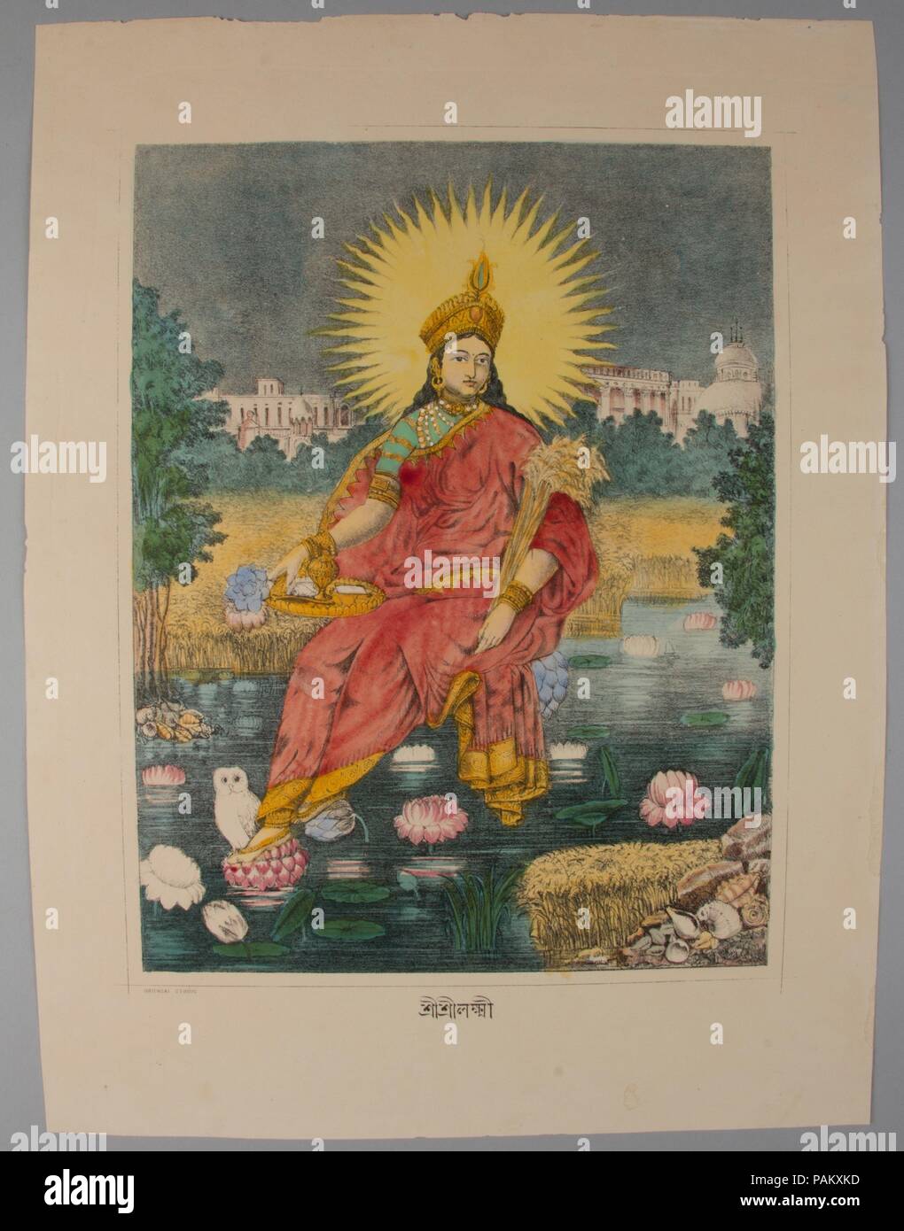 Shri Shri Lakshmi. Culture: India. Dimensions: Image: 11 1/2 × 8 7/8 in. (29.2 × 22.5 cm)  Sheet: 15 3/4 × 12 in. (40 × 30.5 cm). Date: ca. 1880.  Lakshmi enthroned on lotus, with a radiate solar halo, cornucopia-like bundle of wheat and toga-like sari attesting to the strong connection between this print and European depictions of Greek gods.  The buildings in the background juxtapose traditional Bengali temple architecture with the neo-classical European architecture of colonial Calcutta, further amplifying the casting of a traditional deity in neo-classical guise. Museum: Metropolitan Museu Stock Photo