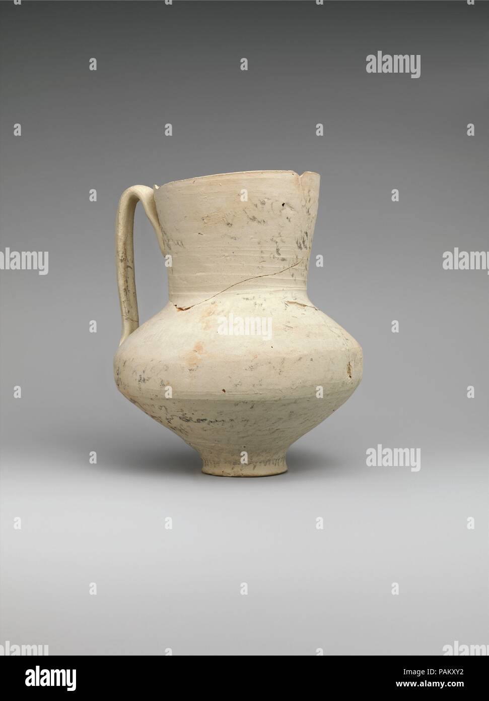 Unglazed Jug with Writing. Dimensions: H. 6 3/4 in. (17.1 cm)  Diam. 5 5/8 in. (14.3 cm). Date: 8th-9th century.  This jug's entire surface is covered with writing, and the faint image of a demon can be discerned on the shoulder. While quite unusual for the Islamic period, this combination of features can be found on a group of sixth- and seventh-century ceramics known as incantation bowls. These bowls were supposed to rid their owners of ailments or to exorcize demons from their homes, and were inscribed with curses in Aramaic, Syriac, and Mandaic. The few known examples of such ceramics from Stock Photo