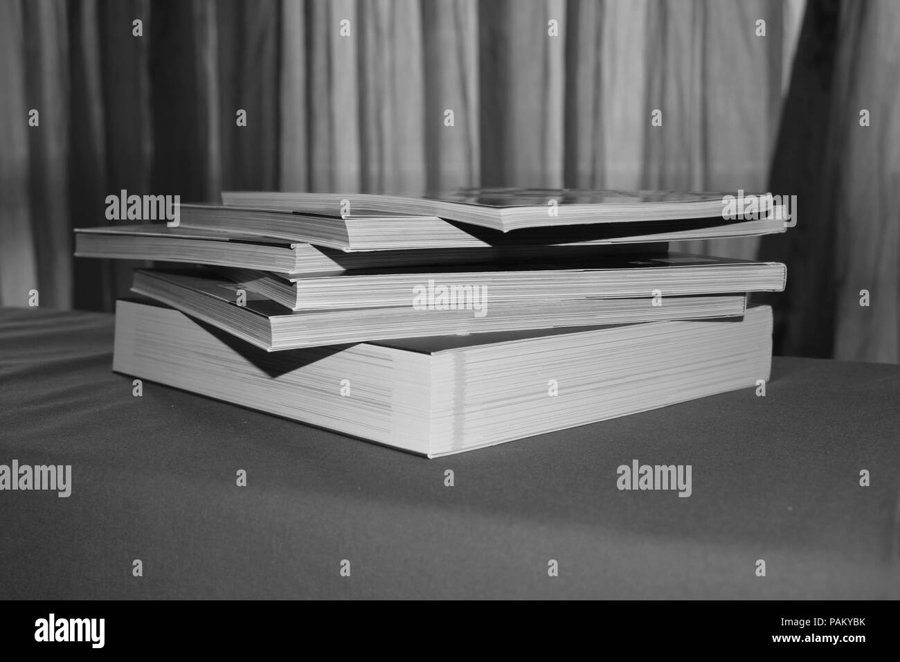 books on a table in black and white Stock Photo