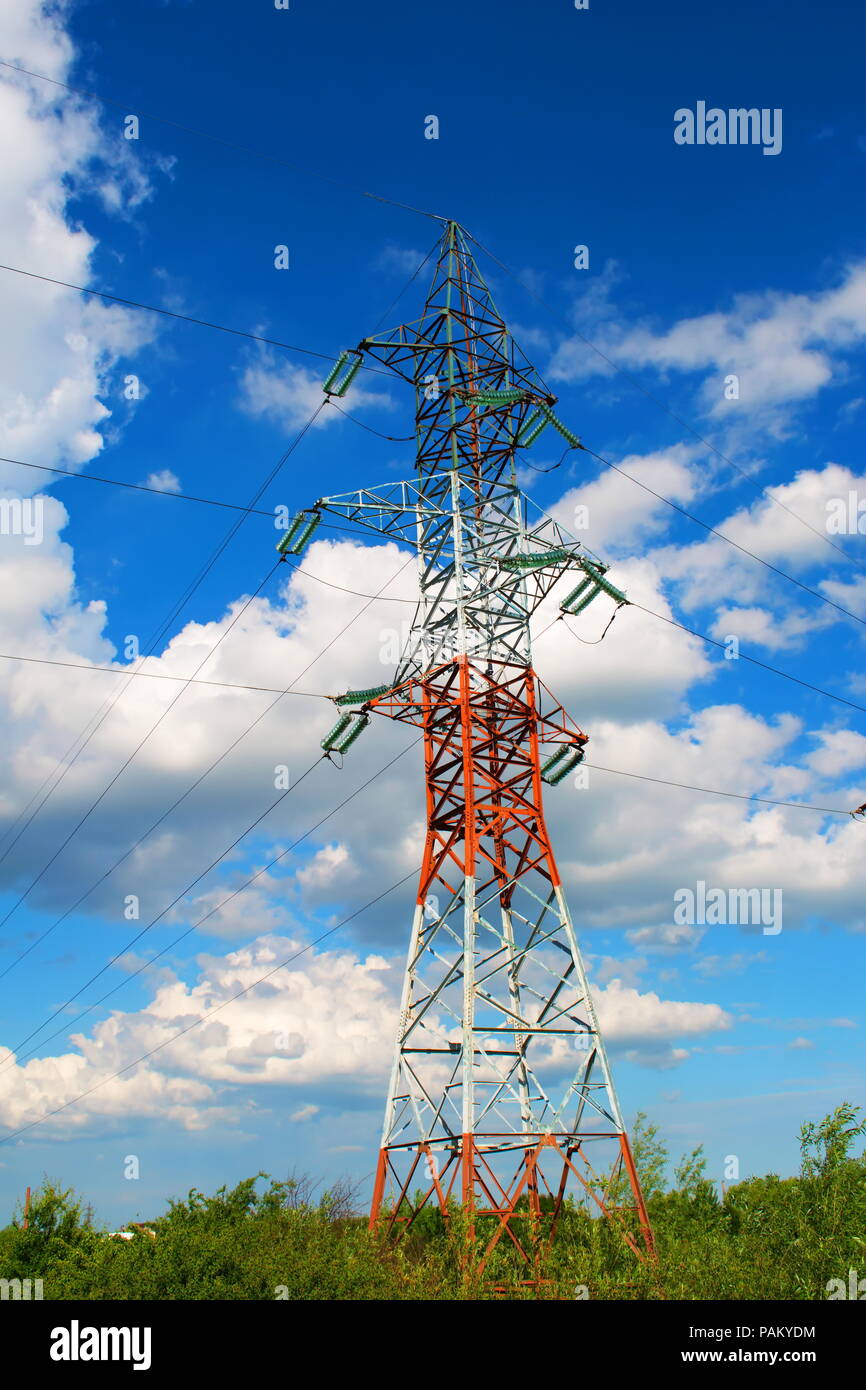 High voltage poles and the blue sky with clouds Stock Photo - Alamy