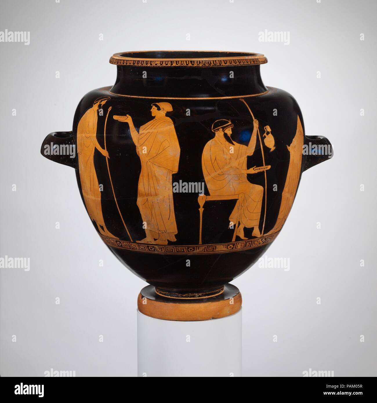 Terracotta stamnos (jar). Culture: Greek, Attic. Dimensions: H. 14 3/8 in. (36.5 cm); diameter of mouth  8 3/4 in. (22.2 cm); diameter of foot  5 15/16 in. (15.1 cm). Date: ca. 480 B.C..  Obverse, men and women  Reverse, men and youths  The Copenhagen and Syriskos Painters were characterized by J. D. Beazley, the authority on Greek vase-painting, as 'brothers.' They belonged to the same workshop, and in some cases as in this stamnos, Beazley was unable to make an attribution to one or the other. Some scholars have speculated that they were one artist.  The subject matter shows two aspects of a Stock Photo