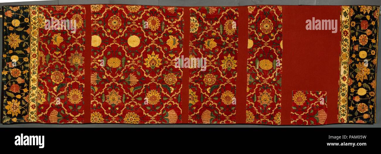 Fragment. Dimensions: H. 14 3/4 in. (37.5 cm)  W. 13 1/4 in. (33.7 cm). Date: ca. 1650.  The original length of this carpet was an impressive thirty feet, indicating its use in a royal building for hosting audiences or other special occasions. Similar trellises enclosing blossoms were also painted on the walls and ceilings of such buildings, and floral friezes covered the dadoes and facades, creating a world of sumptuous flowers surrounding the emperor. Kashmir, with its pashmina shawlweaving tradition, is probably the source of pashmina carpets such as this, but workshops in Lahore also produ Stock Photo