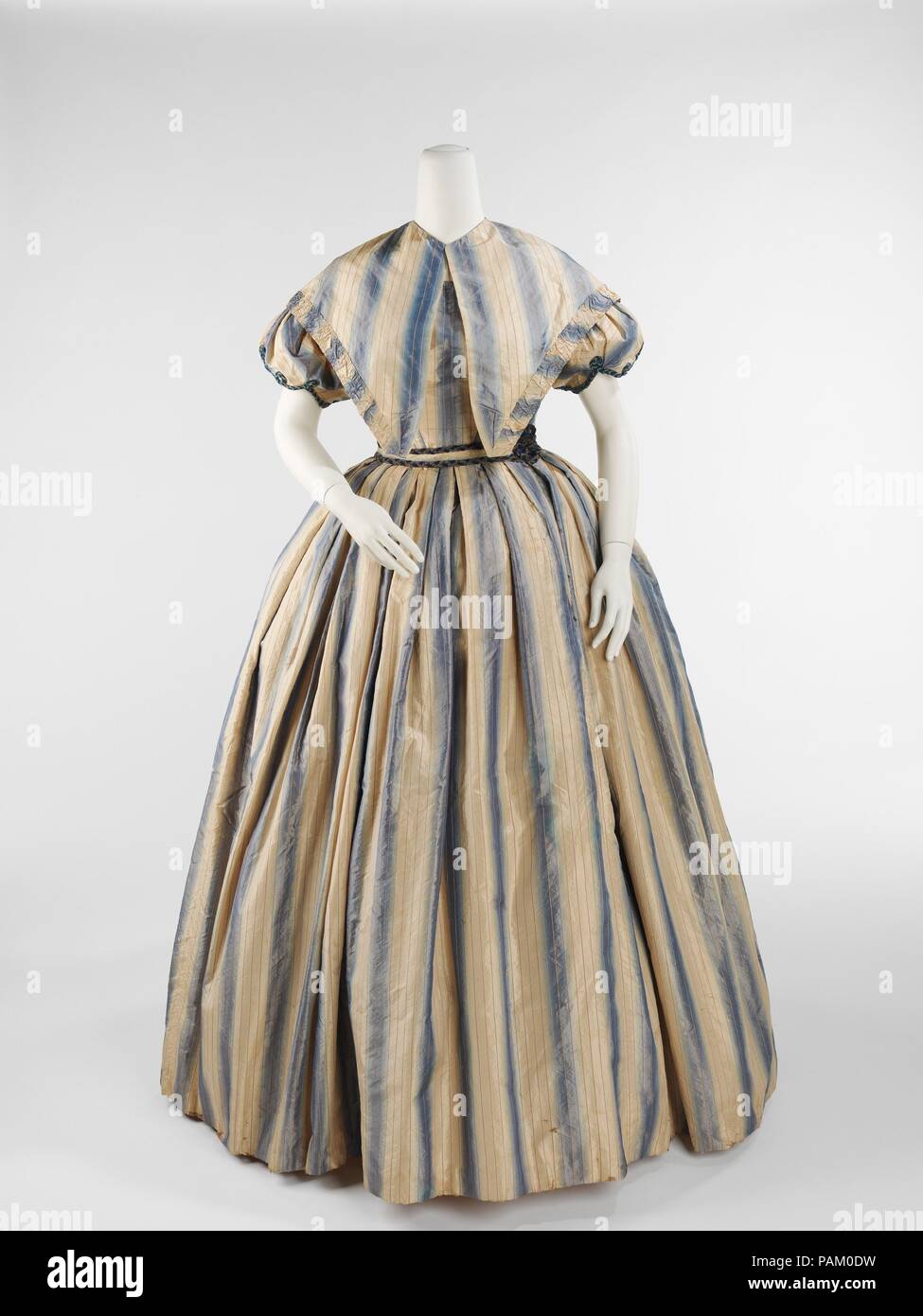 Evening dress. Culture: American. Date: ca. 1848. The female silhouette of the middle of the 19th century consisted of a fitted corseted bodice and wide full skirts. The conical skirts developed between Evening dress. Culture: American. Date: ca. 1848. The female silhouette of the middle of the 19th century consisted of a fitted corseted bodice and wide full skirts. The conical skirts developed between