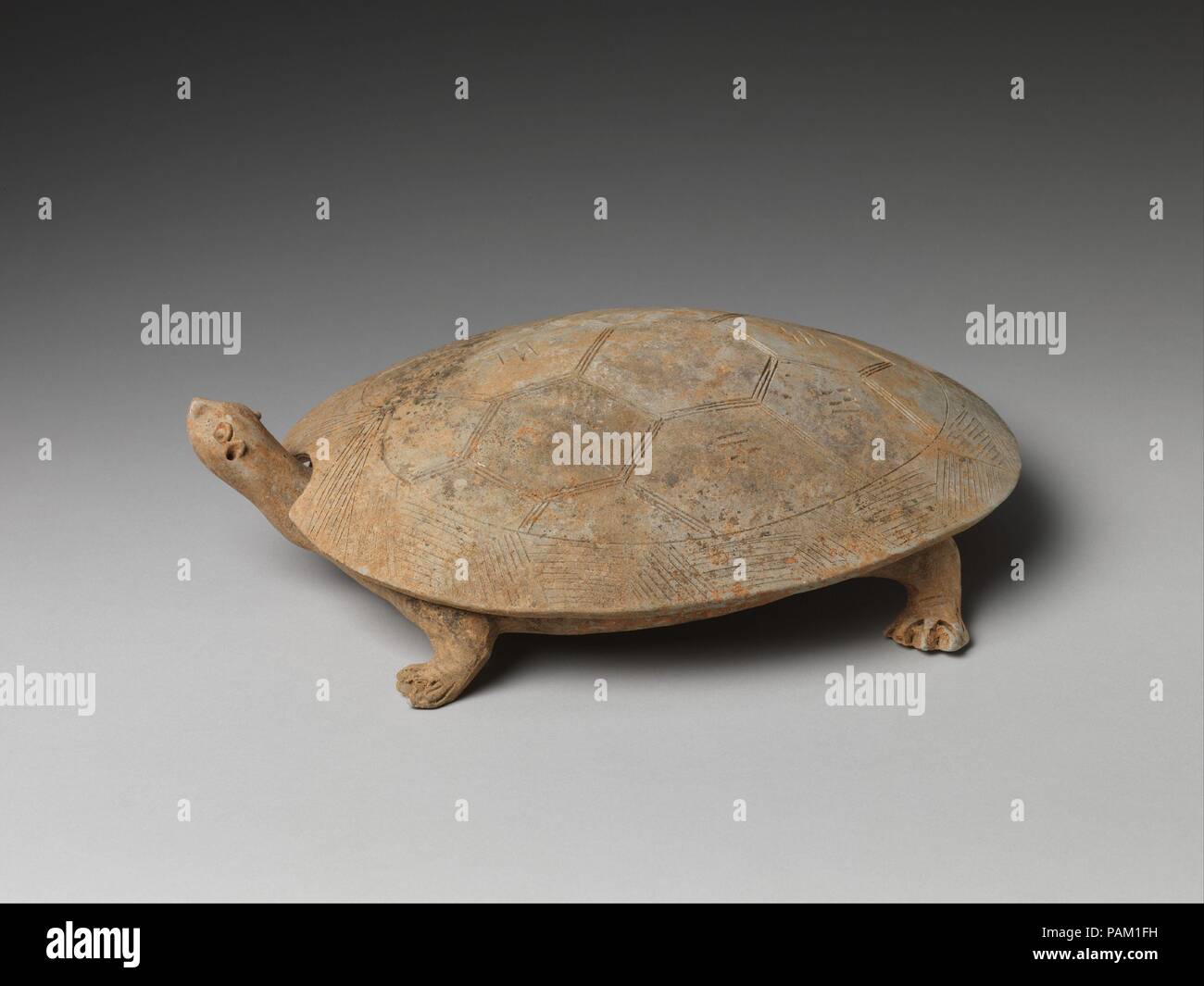 'Inkstone' and Cover in the Shape of a Turtle. Culture: China. Dimensions: H. 3 1/2  in. (8.9 cm);  W. 9 1/4  in. (23.5 cm); L. 11 5/8 in. (29.5 cm). Date: ca. 6th-7th century.  Turtles and tortoises, symbols of longevity and endurance, have long been associated with divination in ancient China. Here, the shell is engraved with the eight trigrams (bagua) used in Daoist cosmology, which became increasingly important during the Sui and Tang dynasties. Museum: Metropolitan Museum of Art, New York, USA. Stock Photo