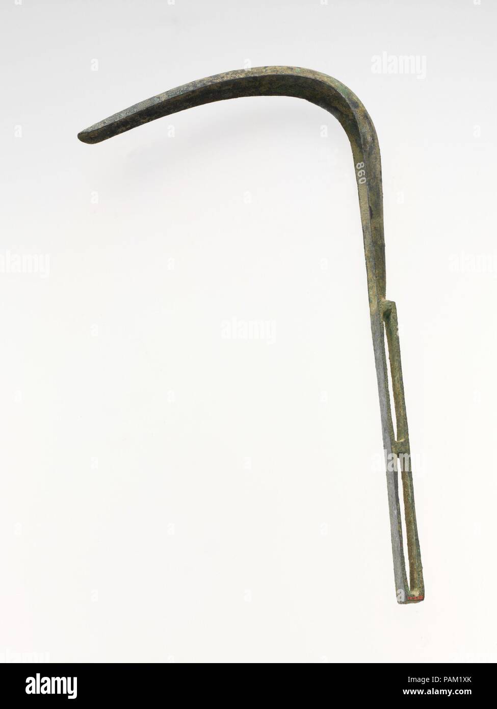 Bronze strigil. Culture: Roman. Dimensions: L. 9 in. (22.8 cm). Date: 1st-2nd century A.D..  The blade is bent to an acute angle. The handle, which is in one piece with the blade, is in the form of a rectangular loop with a cross-piece in the middle. On the back of the handle are incised lines. Museum: Metropolitan Museum of Art, New York, USA. Stock Photo