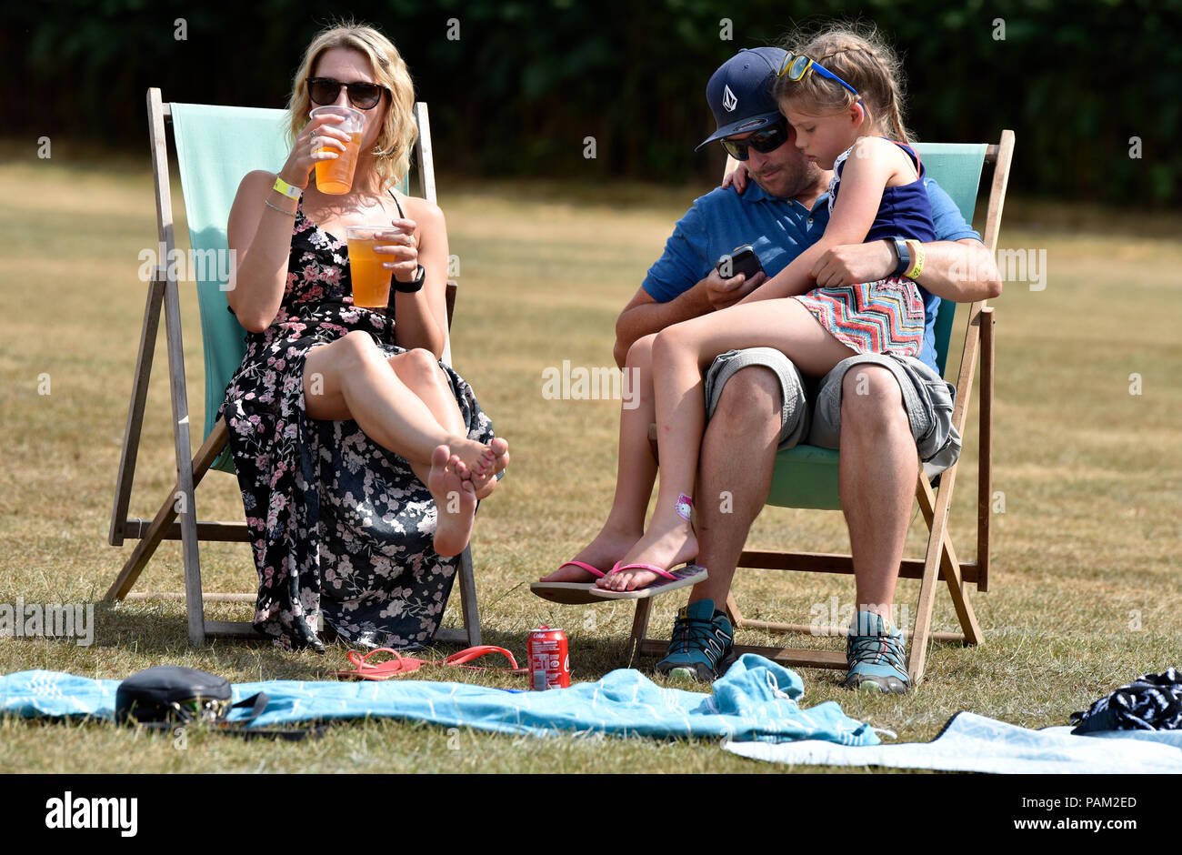 Couple and young daughter attending the McMillfest 2018 music festival, Milland, near Liphook, Hampshire, UK. 21 July 2018. Stock Photo