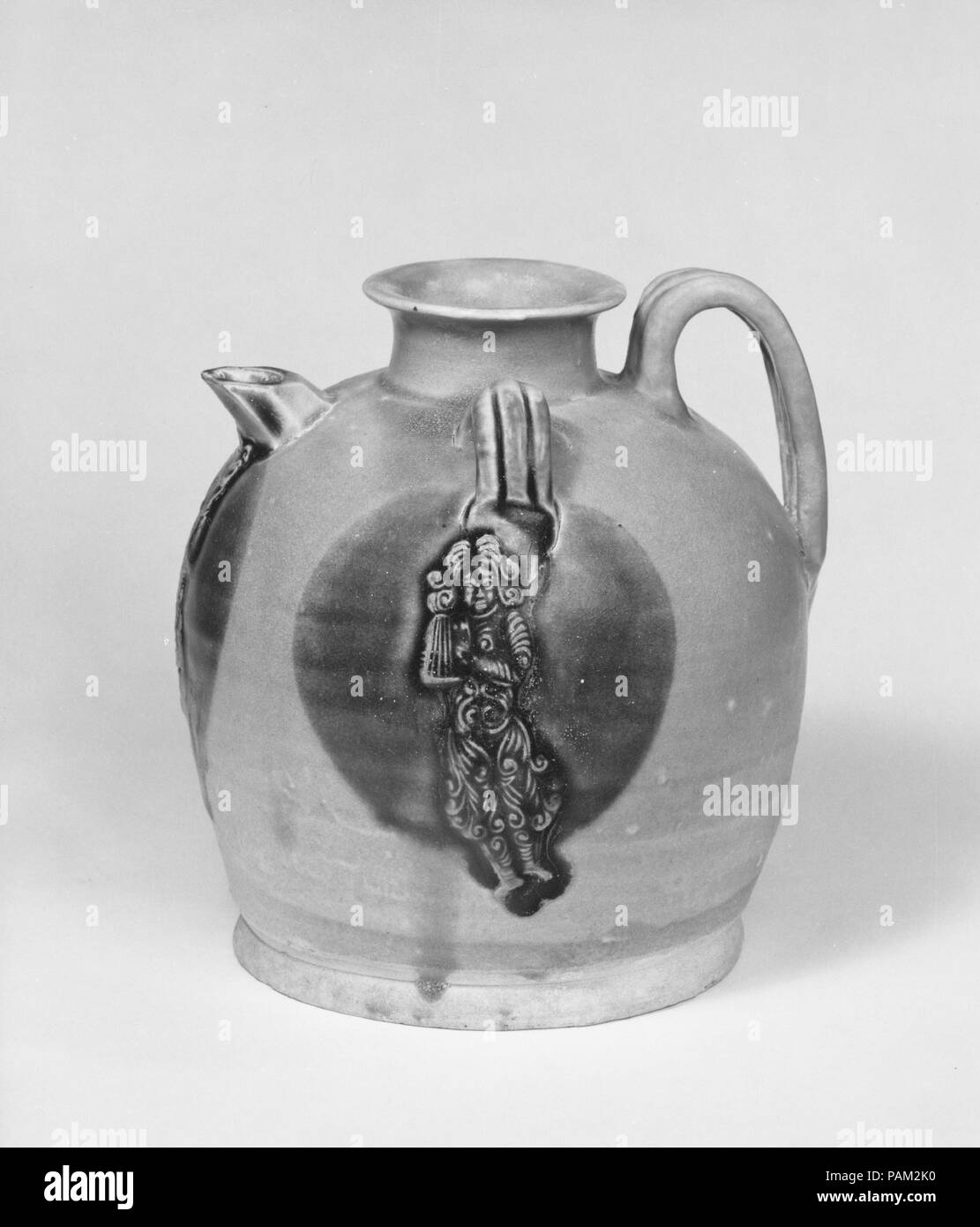 Ewer with Dancing Figure. Culture: China. Dimensions: H. 6 in. (15.2 cm). Date: ca. 9th century.  The curly hair of the dancer appliqued to the ewer suggests that this figure is not of Chinese ethnicity. He may represent a South or Southeast Asian individual, or even someone from Central Asia. Similar dancing figures, depicted on ceramics from north China, often represent Sogdians, a trading people based in present-day Uzbekistan, known for their whirling dances. Museum: Metropolitan Museum of Art, New York, USA. Stock Photo