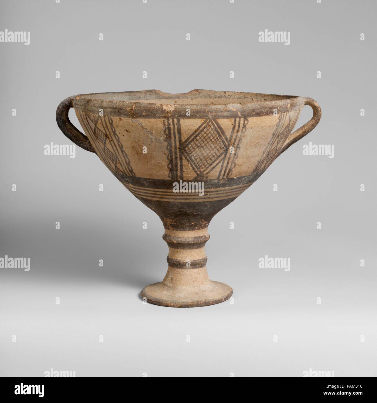 Terracotta stemmed cup. Culture: Cypriot. Dimensions: H. 6 3/4 in. (17.2 cm); diameter  7 5/16 in. (18.6 cm). Date: 1050-950 B.C..  High foot, with lattice designs in panels. Museum: Metropolitan Museum of Art, New York, USA. Stock Photo